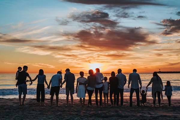 Empowering people – group of people together at a beach during sunset